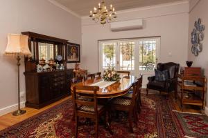 a dining room with a table and chairs at Karos Gastehuis in Loxton