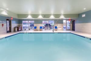 une grande piscine dans une salle de sport aux murs bleus dans l'établissement Holiday Inn Express & Suites - Florence - Cincinnati Airport, an IHG Hotel, à Florence