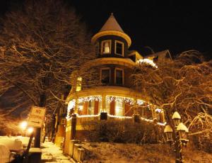 a large house with christmas lights on it at Wilson House Bed & Breakfast in Baltimore