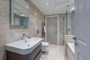 a bathroom with a sink and a toilet and a mirror at Brunswick Place in Bath