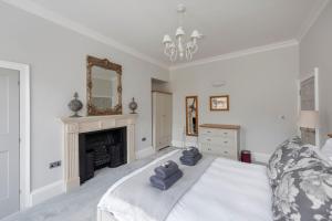 a bedroom with a bed with two towels on it at Brunswick Place in Bath