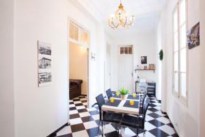 a dining room with a table and chairs on a checkered floor at appartement haussmannien centre ville Casablanca in Casablanca +9 photos