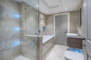 a bathroom with a shower and a tub and a toilet at Brunswick Place in Bath