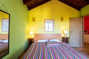 a bedroom with two beds and a yellow wall at Diktamos Villas in Atsipopoulo