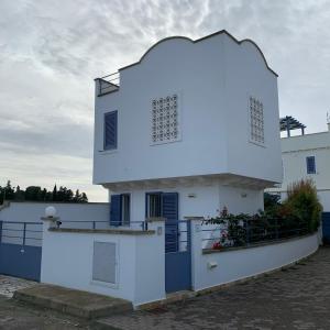 a white building with a dome on top of it at Villa Imma in Torre Lapillo