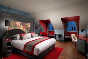 a hotel room with a large bed and a large window at Malmaison Edinburgh City in Edinburgh