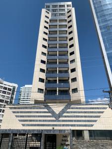 un edificio alto con un cielo azul en el fondo en Flat em Recife a beira-mar de Boa Viagem, en Recife