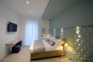 1 dormitorio con 1 cama y TV en All'ombra en Andria