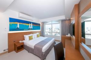 A bed or beds in a room at Ramada by Wyndham Beach Hotel Ajman