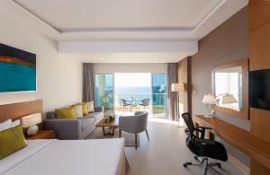 a hotel room with a bed and a room with a view at Ramada by Wyndham Beach Hotel Ajman in Ajman 