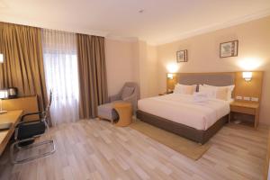 Postel nebo postele na pokoji v ubytování Mado Hotel