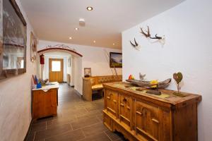 a living room with a wooden dresser in a room at Alpenapart Marina in Nauders