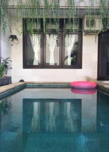 a swimming pool with a red frisbee in it at Villa Indah Kuta Royal - Private Pool - Optic Fiber High Speed Internet in Kuta