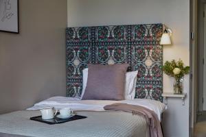 A bed or beds in a room at Hertford House 