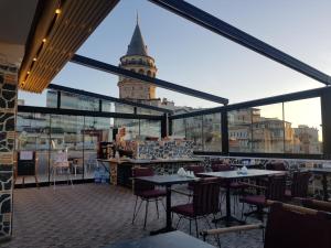 a restaurant with a view of a clock tower at Galatower Hotel in Istanbul