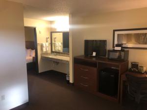 um quarto de hotel com televisão e casa de banho em Cobblestone Hotel & Suites - Wisconsin Rapids em Wisconsin Rapids