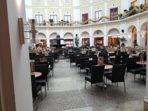 a dining hall with tables and chairs in a building at Heimathaven 2 in Bremerhaven