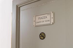 a sign on a door that reads plaza guard of iron at La Maison Dell'Orologio in Rome