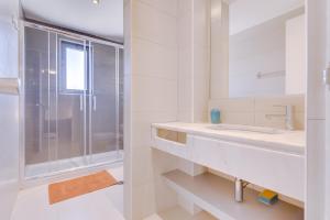 a bathroom with a sink and a shower at Cruzeiro do Sul Apartments - Vilamoura center in Vilamoura +57 photos
