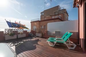 two chairs sitting on the deck of a building at Llar de Capitans in Masnou