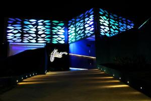 a building with blue lights on the side of it at Flow Motel (Adult Only) in Valinhos