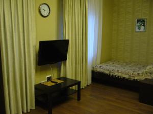 カルーガにあるAelitaのベッド、テーブル、テレビが備わる客室です。