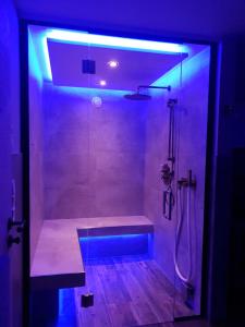 a bathroom with a shower with a blue light at Landhaus Schatz in Nesselwängle