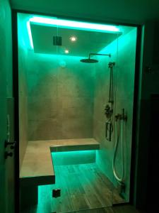 a bathroom with a shower with a blue light at Landhaus Schatz in Nesselwängle