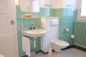 a bathroom with a sink and a toilet at Guest Rooms with a great view at Residence Brunner in Wengen