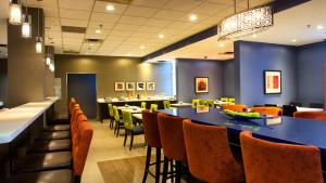 a dining room with a long table and chairs at Holiday Inn & Suites Mississauga West - Meadowvale by IHG in Mississauga +29 photos