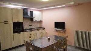 a kitchen with a table and chairs in a room at Ca' Nova in Roccaforte Mondovì