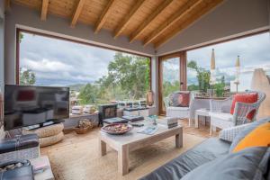 a living room with a couch and a tv at Herdade Quinta Natura Turismo Rural in Aljezur