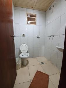 a small bathroom with a toilet and a sink at Hotel Goll in Limeira