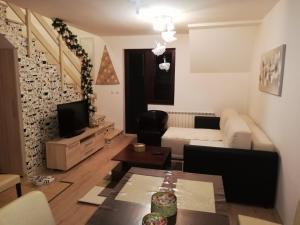 a living room with a couch and a table at Gorštak in Kopaonik