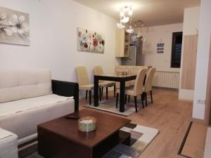 a living room with a couch and a table at Gorštak in Kopaonik