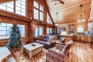 a living room filled with furniture and a christmas tree at Grand Lake Grandeur in Grand Lake