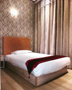 Postel nebo postele na pokoji v ubytování Igiban Hotel