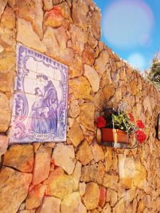 a stone wall with a picture of a girl on it at Herdade Quinta Natura Turismo Rural in Aljezur