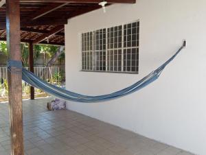 a hammock hanging on a wall next to a window at Pousada Marazul in Maceió
