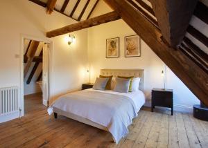 a bedroom with a large white bed in a attic at Host & Stay - The Coach House in Whitby