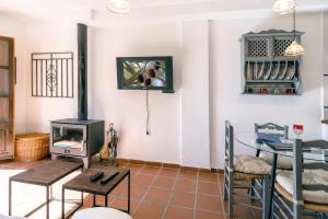 a living room with a stove and a table at Casa Consuelo in Capileira