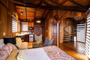 a living room with a bed and a kitchen at Lucero Residences Golf & Wellness Resort in Boquete +58 photos