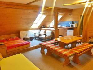 a living room with a bed and a table at Kubovka 63 in Kubova Huť