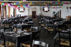 a dining room with tables and chairs and decorations at Hotel Montetaxco in Taxco de Alarcón +37 photos