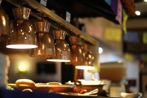 a group of lights hanging from a shelf with dishes at Hotel Montetaxco in Taxco de Alarcón