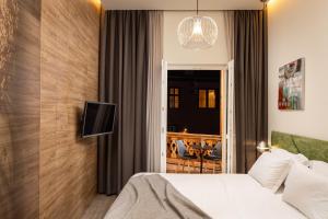a hotel room with a bed and a tv on a wall at Oldern House in Braşov