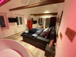 a living room with a black couch in a room at Auszeit Vienna Wellness Apartment in Vienna