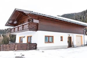 a house with a balcony in the snow at Bucheggerhof in Schladming