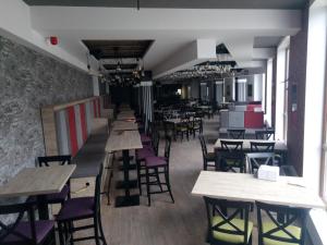 a row of tables and chairs in a restaurant at Šilja Kopaonik S45 Milmari in Kopaonik