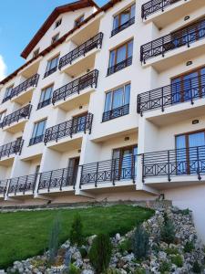 a building with balconies on the side of it at Šilja Kopaonik S45 Milmari in Kopaonik